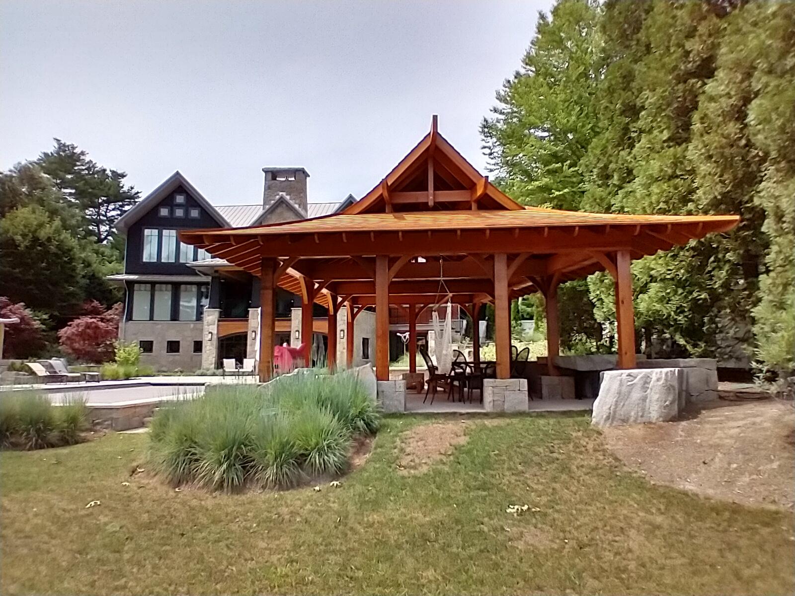 This is a photo of the LT Farm Pool Pavilion Pagoda from the edge of the garden adjacent to the farm yard, looking back up at the pagoda with the main house in the background.